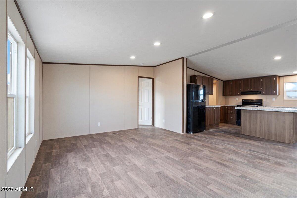 53512 West Organ Pipe Road Maricopa, AZ 85139 - Photo 10 of 44 a view of kitchen with refrigerator and wooden floor