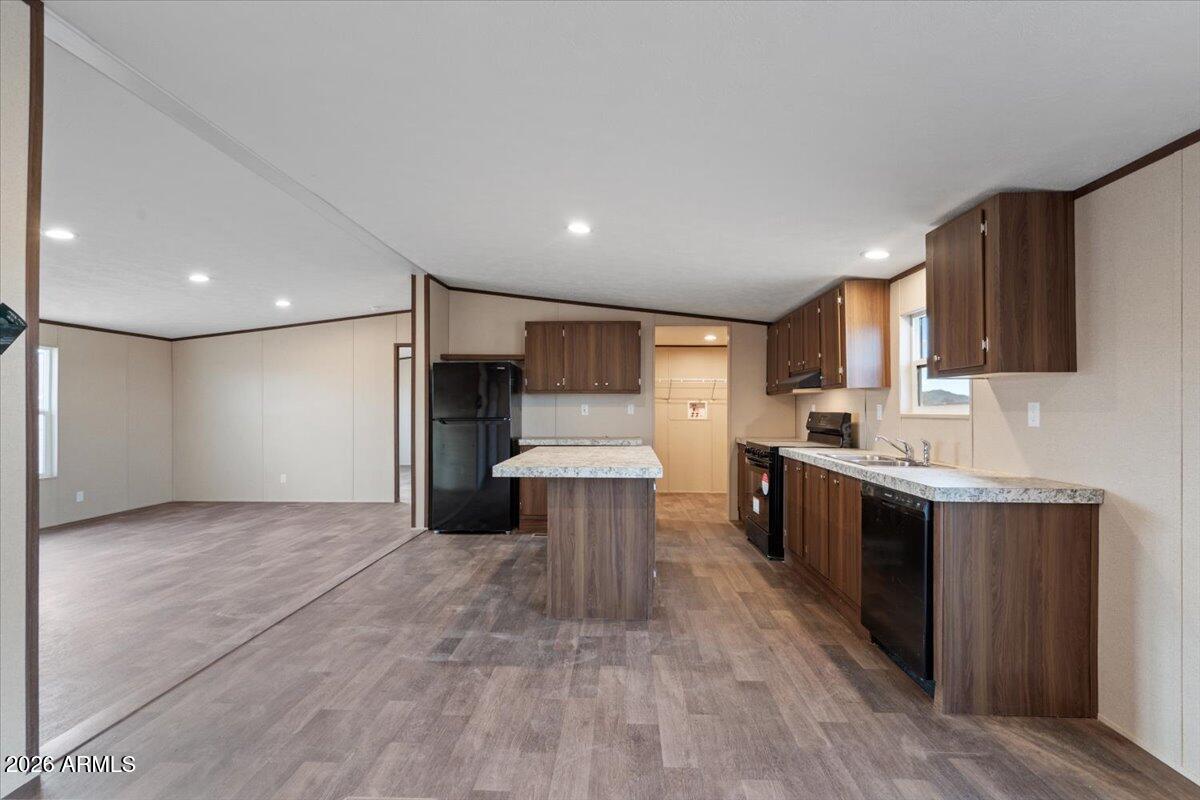 53512 West Organ Pipe Road Maricopa, AZ 85139 - Photo 14 of 44 a kitchen with stainless steel appliances granite countertop a refrigerator a sink dishwasher a stove and a microwave oven on granite countertops