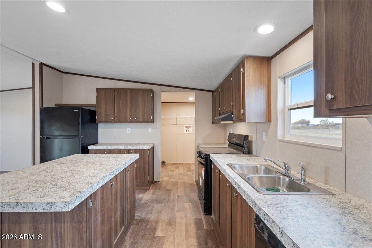 53512 West Organ Pipe Road Maricopa, AZ 85139 - Photo 16 of 44 a kitchen with a stove sink and cabinets