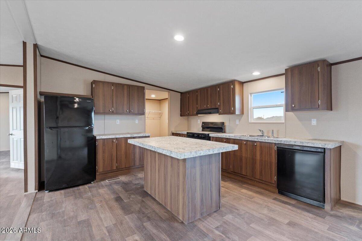 53512 West Organ Pipe Road Maricopa, AZ 85139 - Photo 17 of 44 a kitchen with granite countertop a sink and a refrigerator