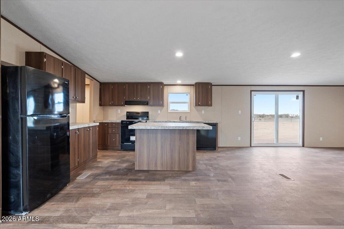 53512 West Organ Pipe Road Maricopa, AZ 85139 - Photo 18 of 44 a kitchen with stainless steel appliances granite countertop a refrigerator a sink a stove and a oven