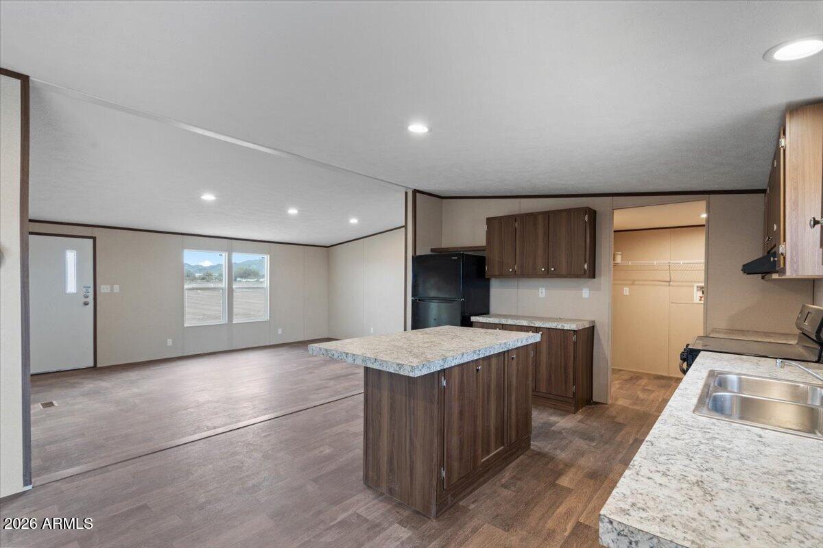53512 West Organ Pipe Road Maricopa, AZ 85139 - Photo 19 of 44 a large kitchen with stainless steel appliances granite countertop a sink and a stove