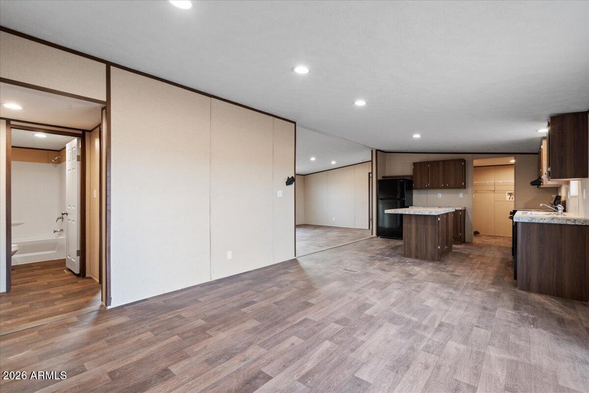53512 West Organ Pipe Road Maricopa, AZ 85139 - Photo 28 of 44 a view of kitchen with refrigerator and wooden floor