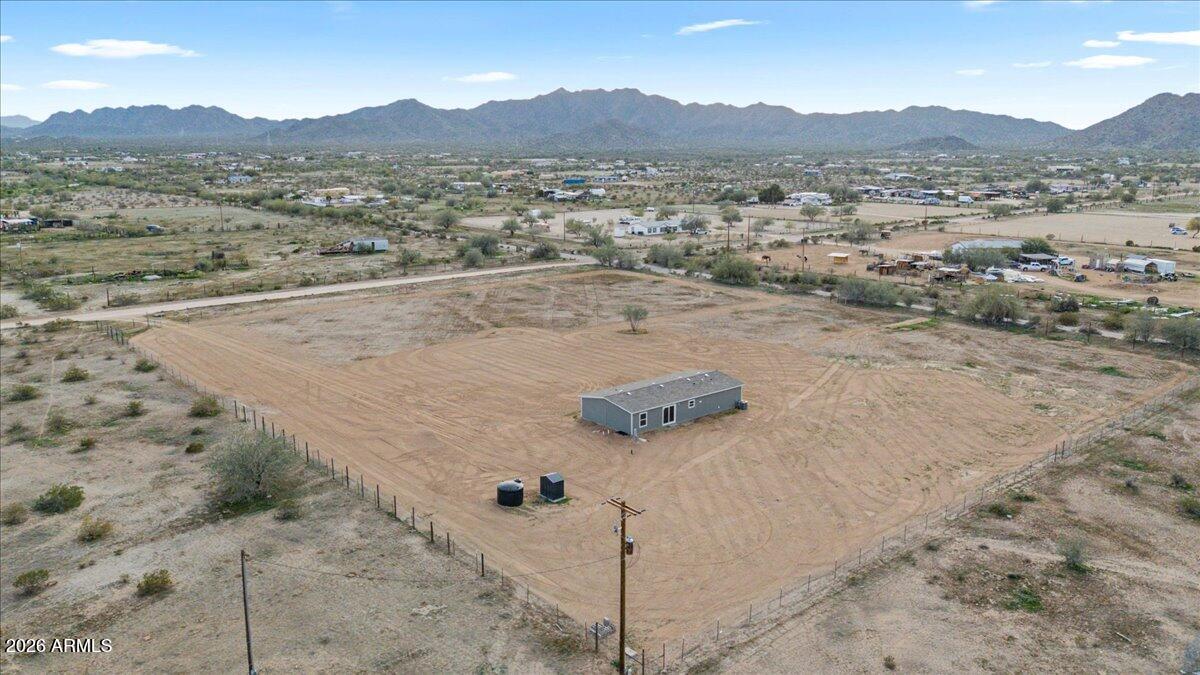 53512 West Organ Pipe Road Maricopa, AZ 85139 - Photo 38 of 44 a view of a dry field with mountains in the background