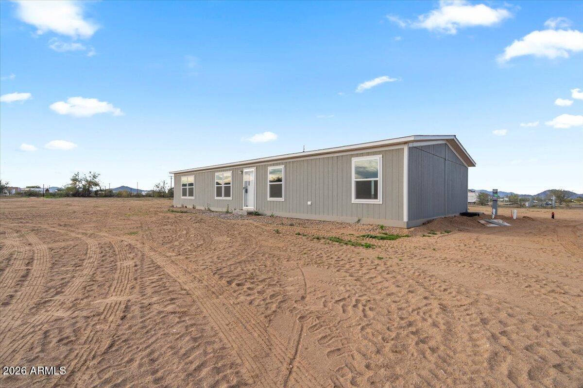 53512 West Organ Pipe Road Maricopa, AZ 85139 - Photo 5 of 44 a view of an house with backyard and bushes