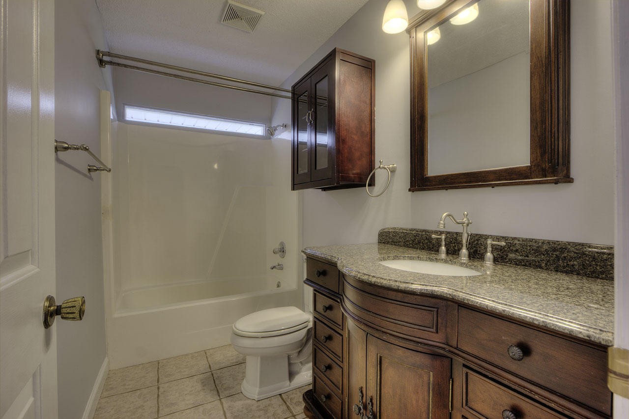 428 Ferret Road Knoxville, TN 37934 - Photo 28 of 38 a bathroom with a granite countertop sink toilet and shower