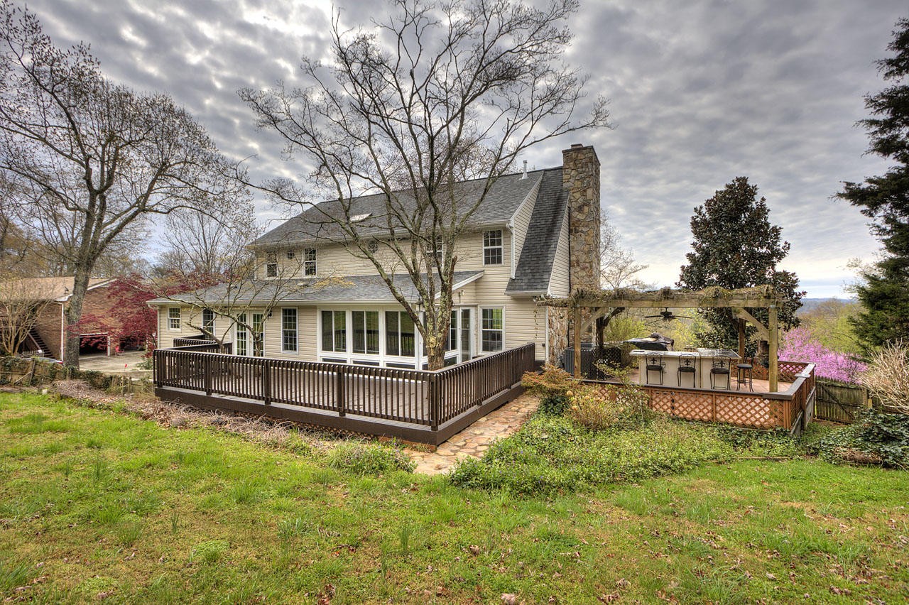 428 Ferret Road Knoxville, TN 37934 - Photo 4 of 38 a view of a house with a yard outdoor seating and covered with trees