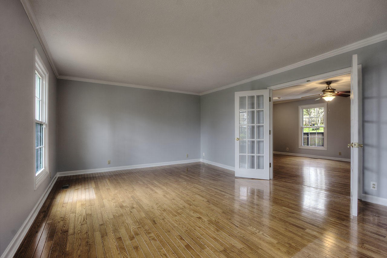 428 Ferret Road Knoxville, TN 37934 - Photo 5 of 38 an empty room with wooden floor and windows