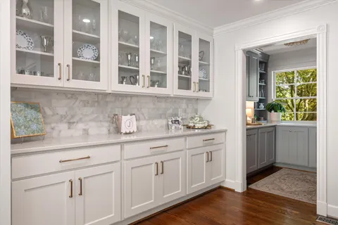 a view of a bedroom with a window and a dresser