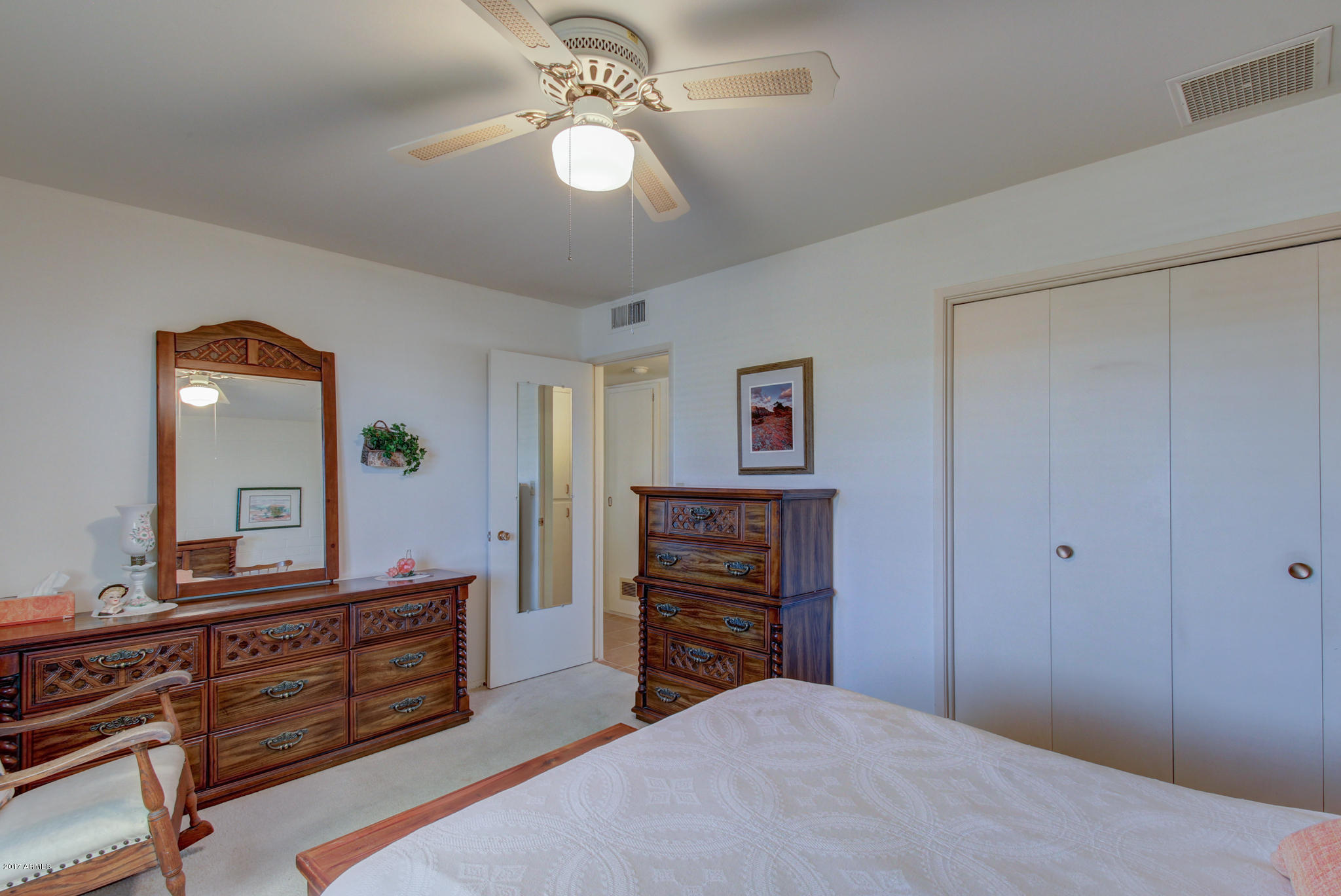 10008 West Riviera Drive Sun City, AZ 85351 - Photo 23 of 26 a bedroom with a bed and a dresser