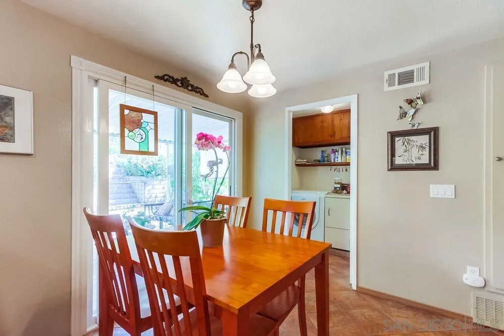 9140 Inverness Road Santee, CA 92071 - Photo 14 of 41 a dining room with furniture a chandelier and wooden floor