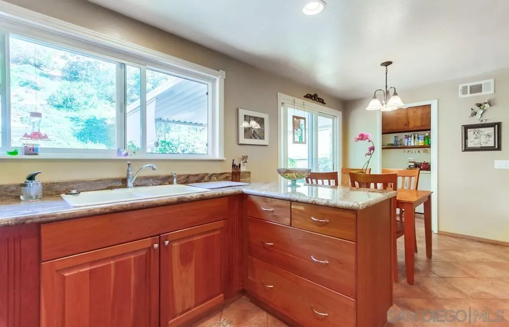 9140 Inverness Road Santee, CA 92071 - Photo 16 of 41 a kitchen with a sink window and cabinets