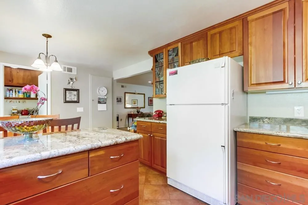 9140 Inverness Road Santee, CA 92071 - Photo 17 of 41 a kitchen view with granite countertop cabinets and refrigerator