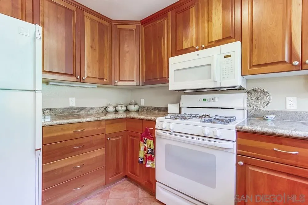 9140 Inverness Road Santee, CA 92071 - Photo 18 of 41 a kitchen with granite countertop cabinets appliances and a sink