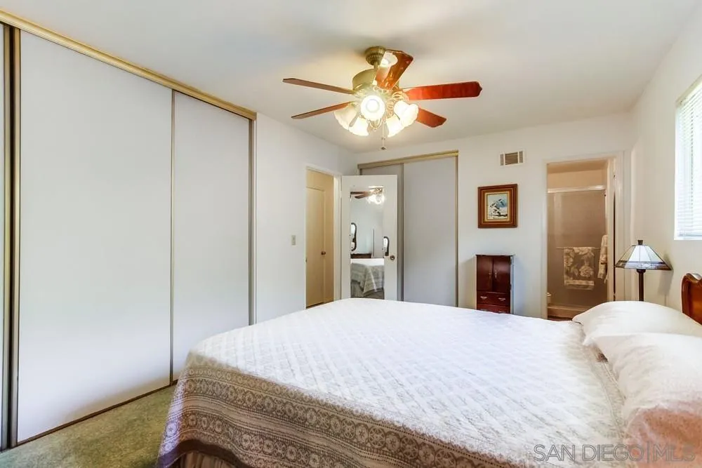 9140 Inverness Road Santee, CA 92071 - Photo 23 of 41 a bedroom with a bed and a chandelier