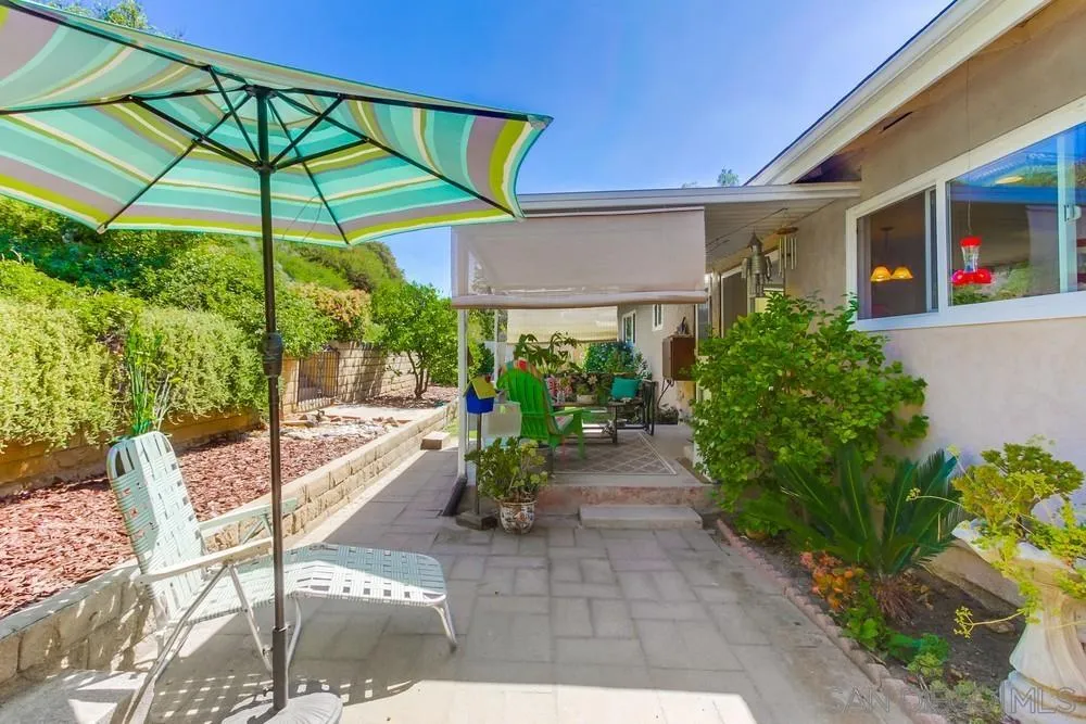 9140 Inverness Road Santee, CA 92071 - Photo 34 of 41 a view of a chair and tables in the patio with a backyard