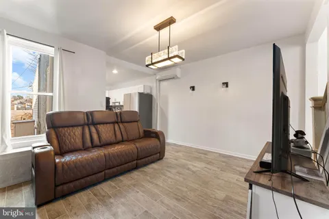 a living room with a couch and a chandelier