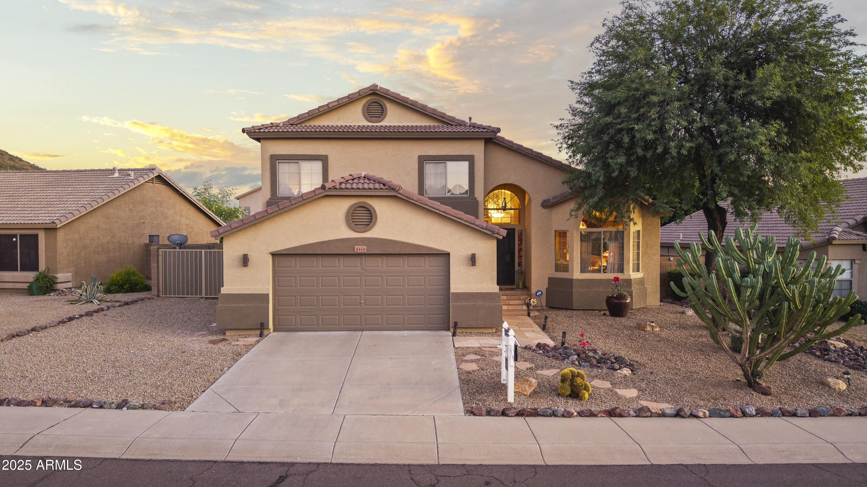 6419 West Briles Road Phoenix, AZ 85083 - Photo 1 of 28 a front view of a house with garden