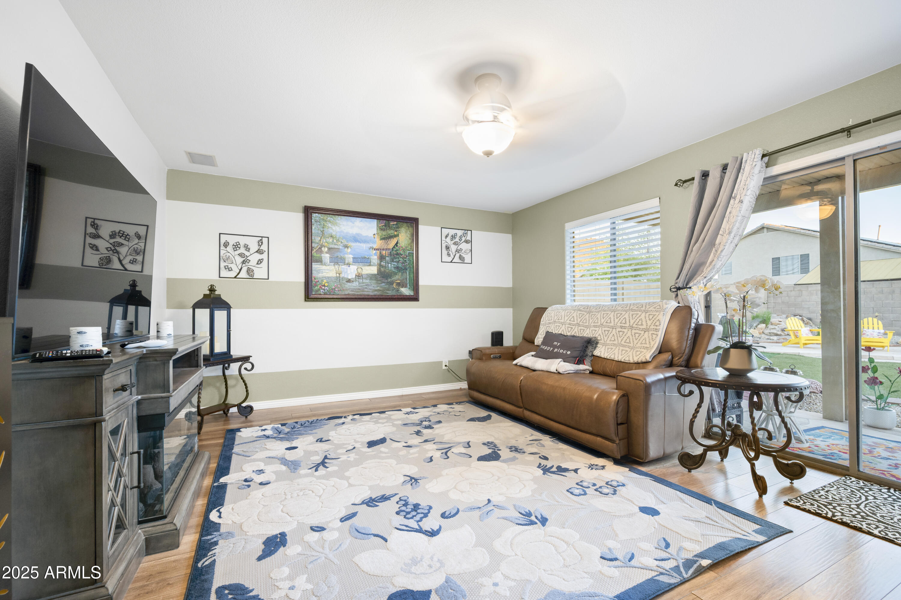 6419 West Briles Road Phoenix, AZ 85083 - Photo 11 of 28 a living room with furniture and a flat screen tv