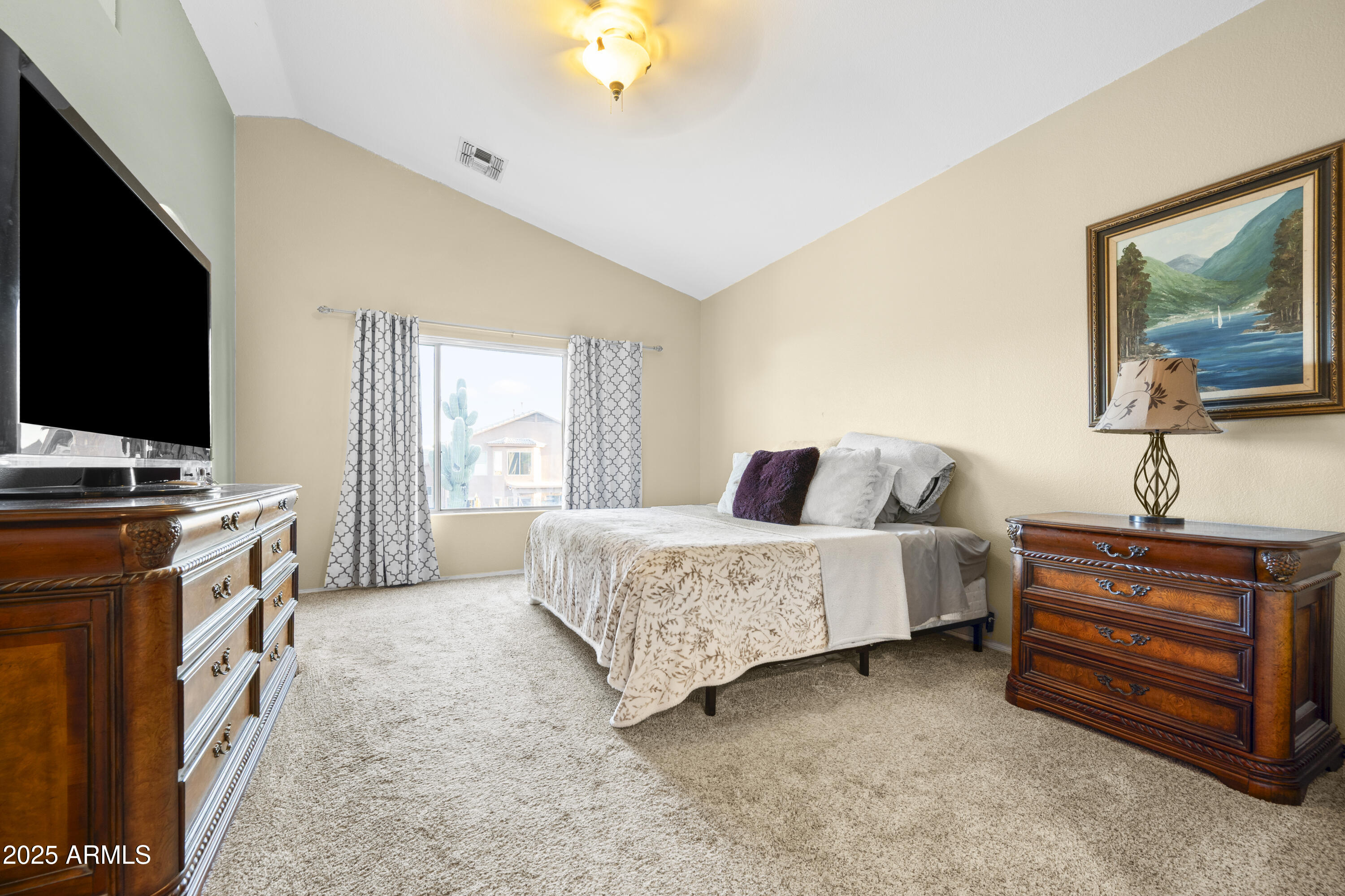 6419 West Briles Road Phoenix, AZ 85083 - Photo 17 of 28 a spacious bedroom with a bed and a flat screen tv