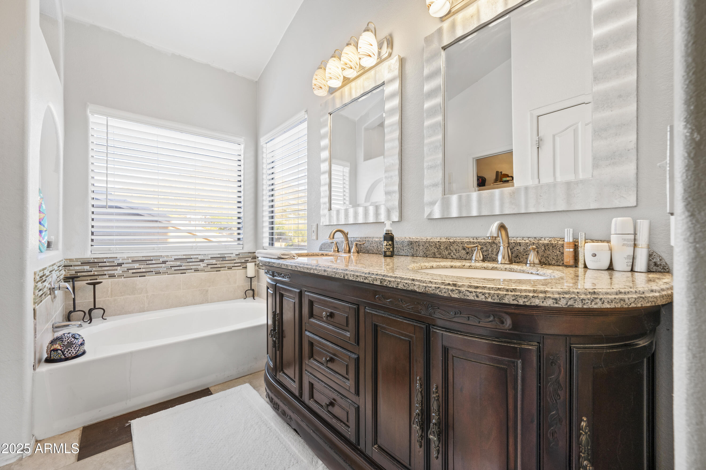 6419 West Briles Road Phoenix, AZ 85083 - Photo 19 of 28 a bathroom with a granite countertop sink and a bathtub