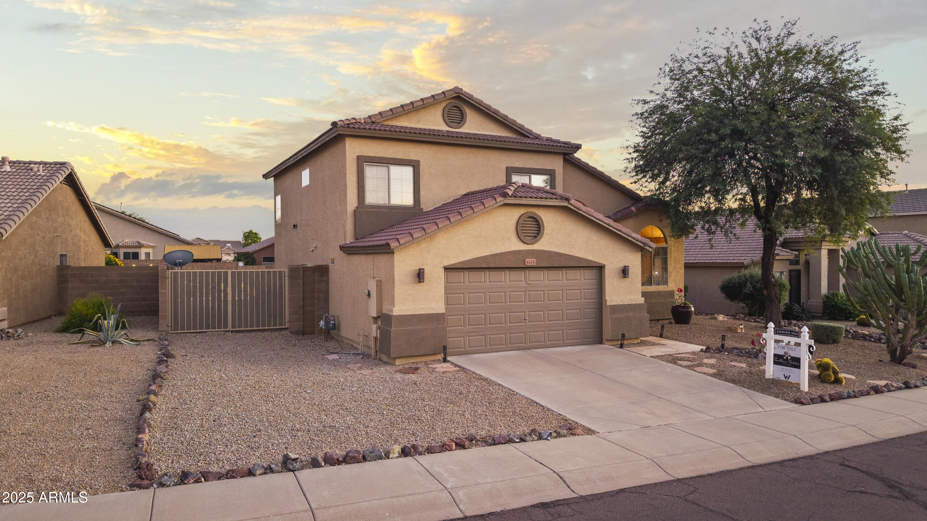 6419 West Briles Road Phoenix, AZ 85083 - Photo 2 of 28 a front view of a house with a yard and garage