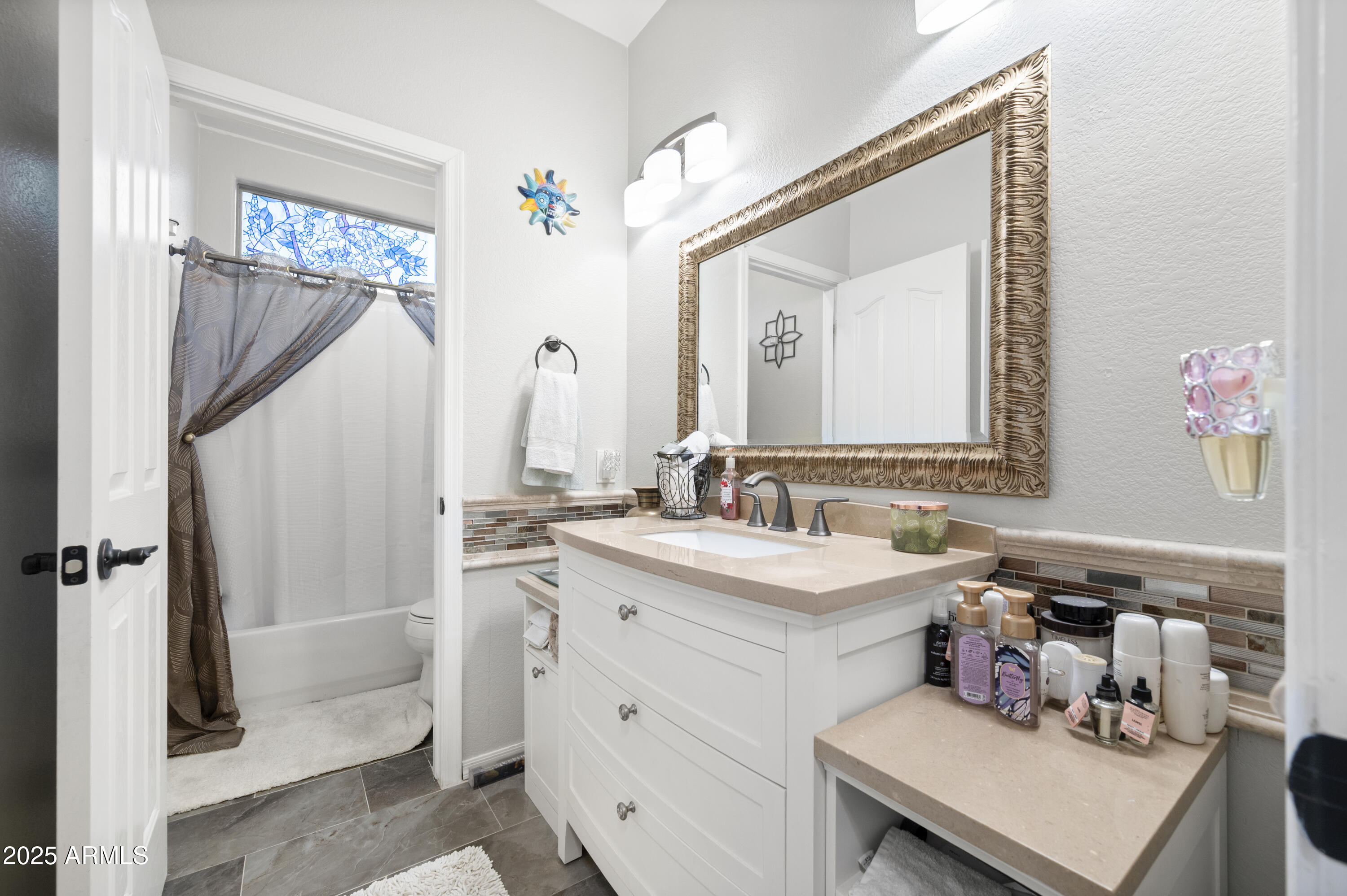 6419 West Briles Road Phoenix, AZ 85083 - Photo 24 of 28 a bathroom with a sink vanity and a mirror