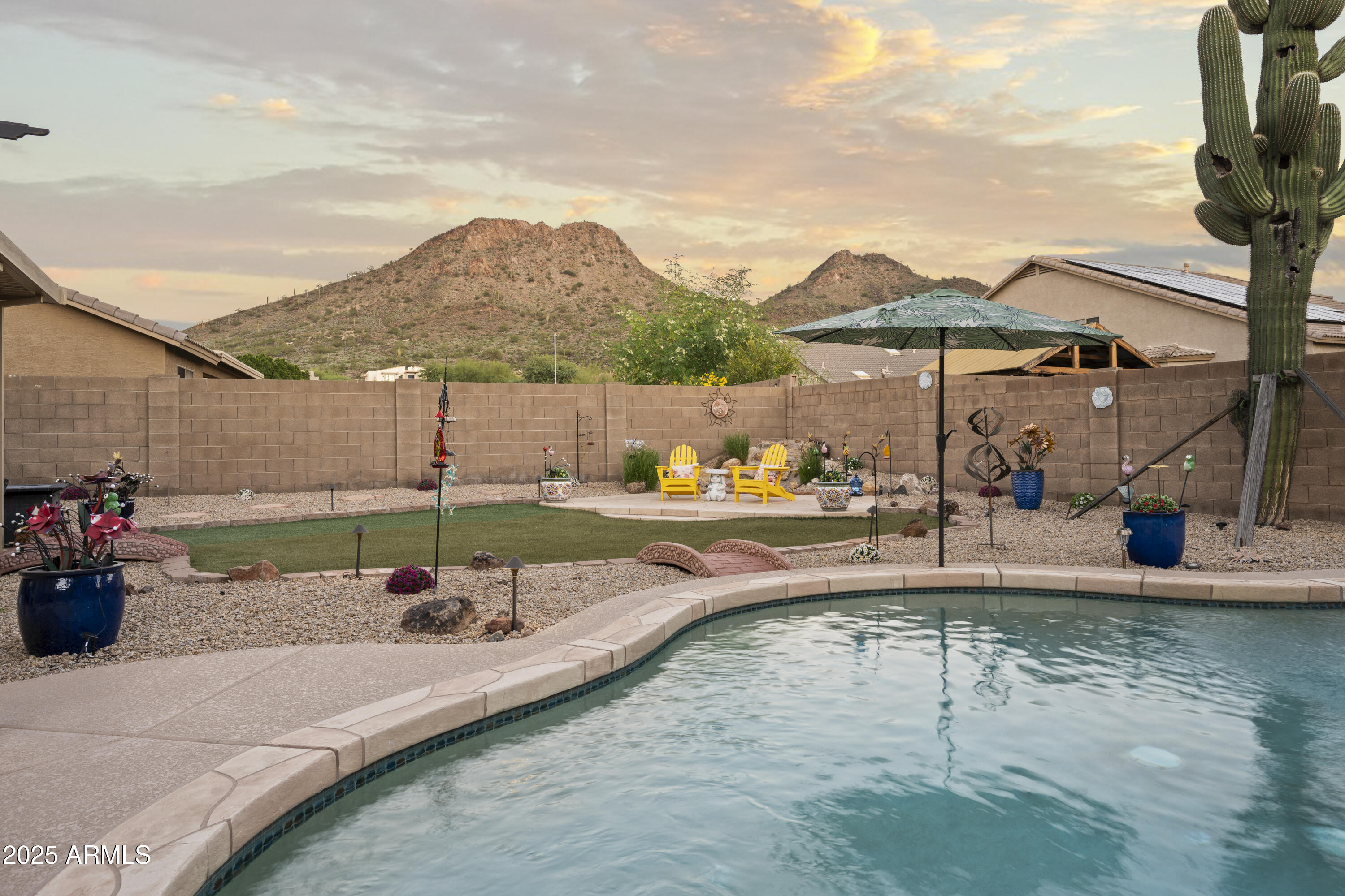 6419 West Briles Road Phoenix, AZ 85083 - Photo 26 of 28 a view of a swimming pool with a patio and a garden