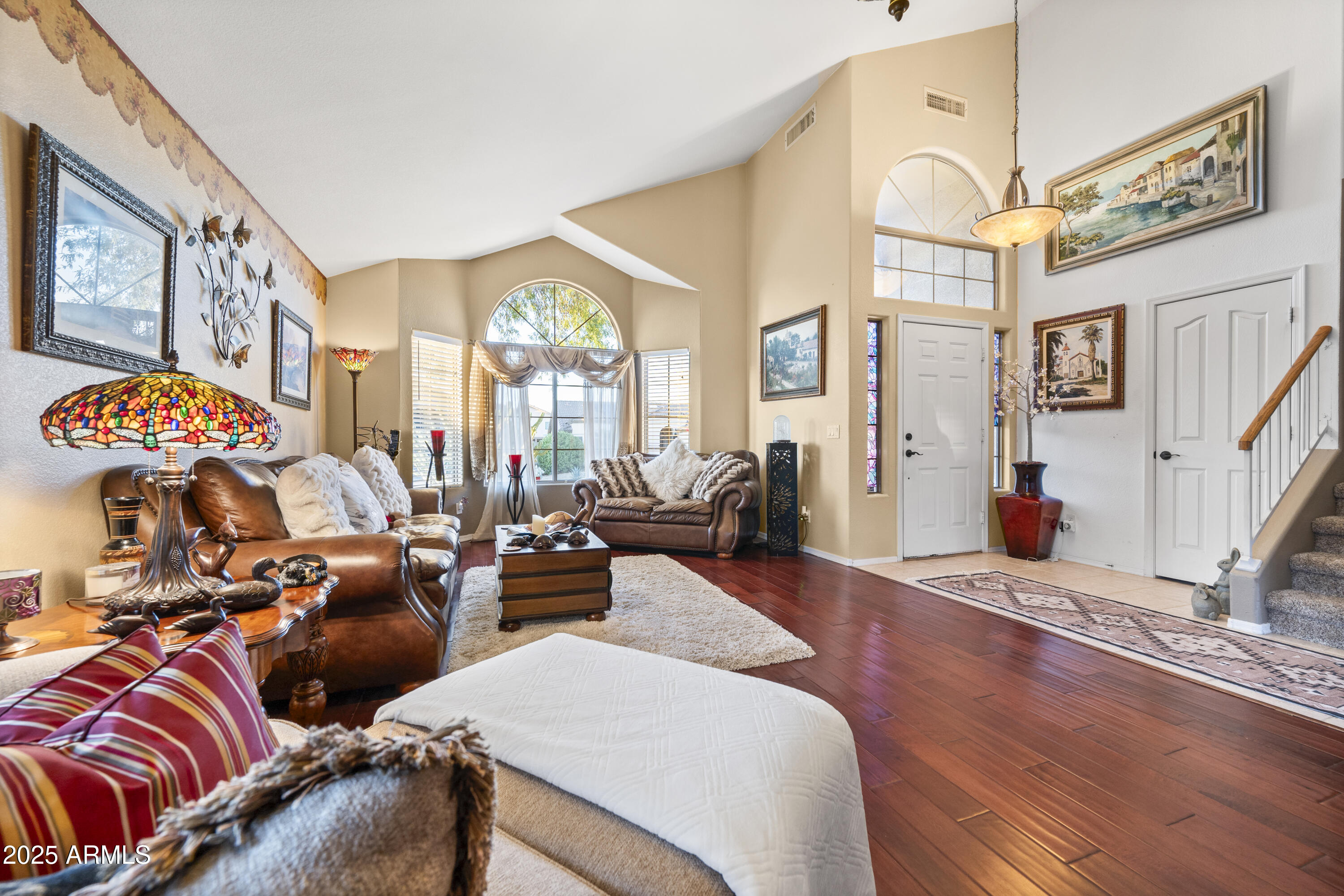 6419 West Briles Road Phoenix, AZ 85083 - Photo 5 of 28 a living room with furniture and a floor to ceiling window