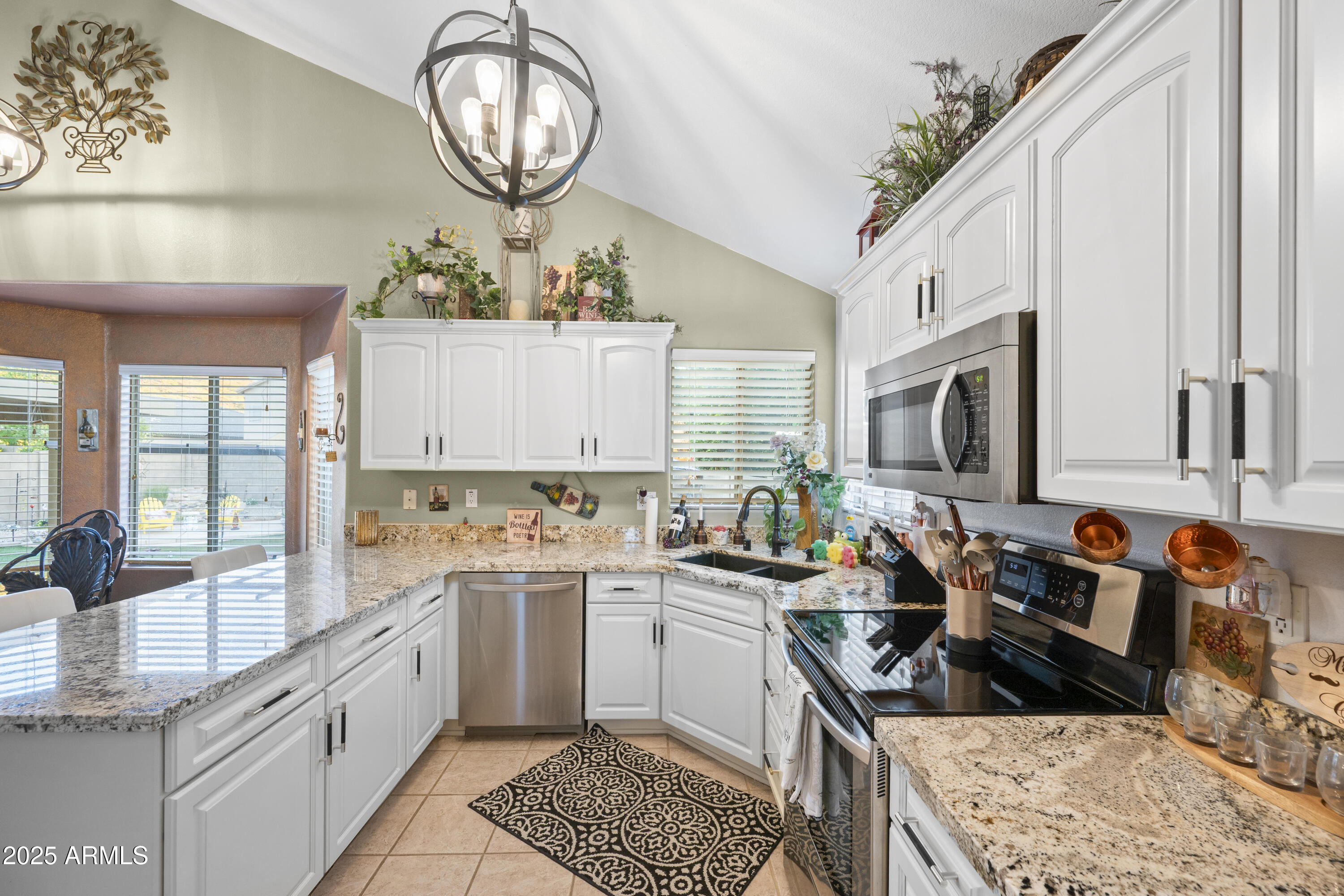 6419 West Briles Road Phoenix, AZ 85083 - Photo 9 of 28 a kitchen with stainless steel appliances a sink stove and cabinets