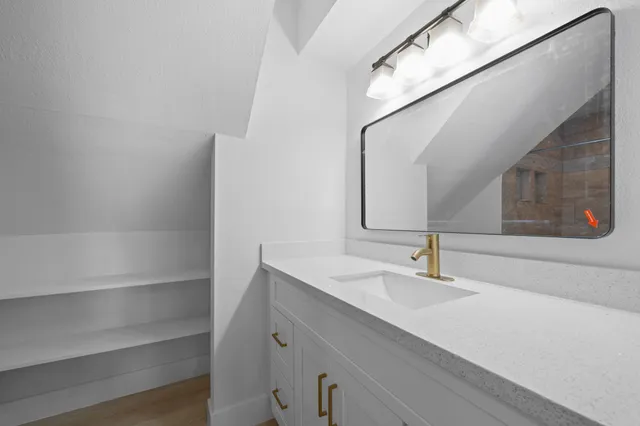 a bathroom with a sink and a mirror