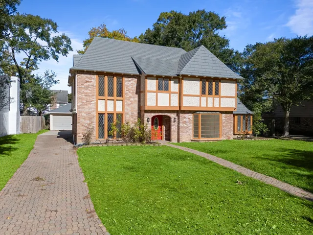 a front view of a house with a yard and porch