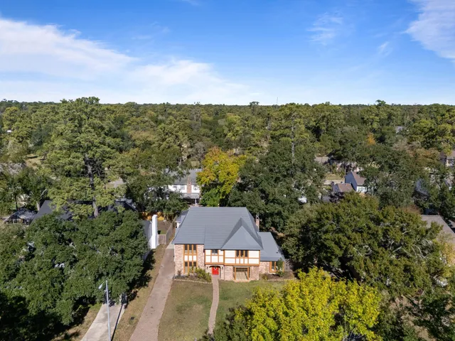 an aerial view of a house with a yard
