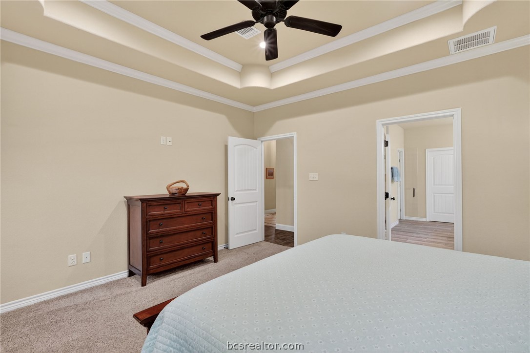 2004 Lexi Lane Bryan, TX 77807 - Photo 20 of 47 a bedroom with a bed and a chandelier