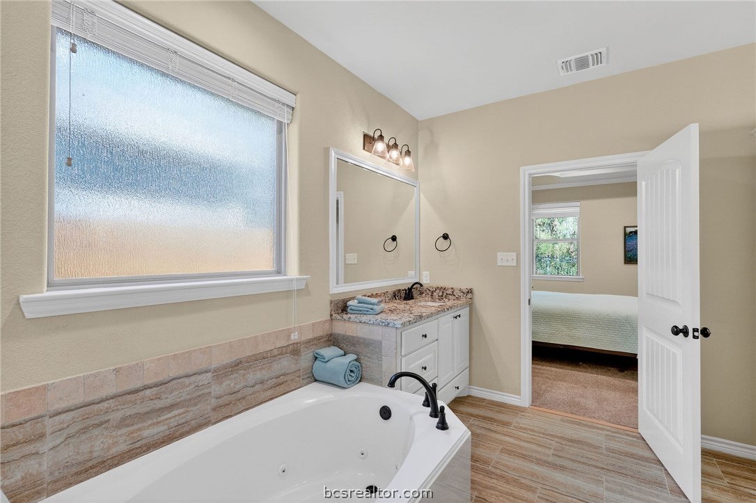 2004 Lexi Lane Bryan, TX 77807 - Photo 23 of 47 a bathroom with a tub and a window