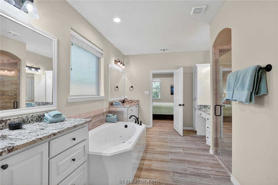 2004 Lexi Lane Bryan, TX 77807 - Photo 25 of 47 a spacious bathroom with a granite countertop sink and a mirror