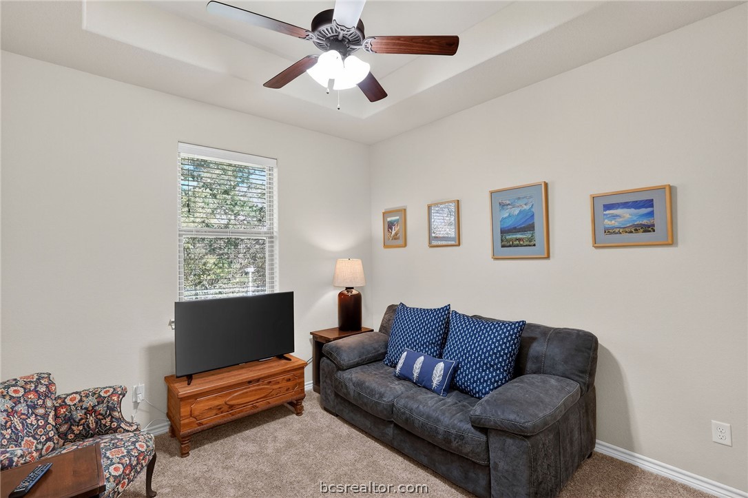 2004 Lexi Lane Bryan, TX 77807 - Photo 30 of 47 a living room with furniture a ceiling fan and a window