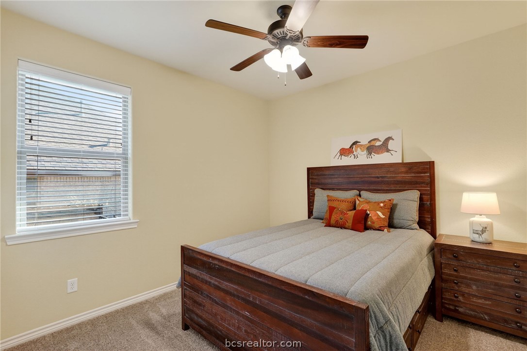 2004 Lexi Lane Bryan, TX 77807 - Photo 32 of 47 a bedroom with a bed and a chandelier