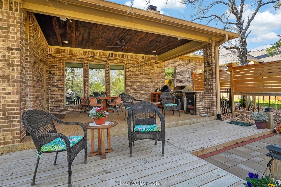 2004 Lexi Lane Bryan, TX 77807 - Photo 39 of 47 a view of a patio with table and chairs with wooden floor and fence