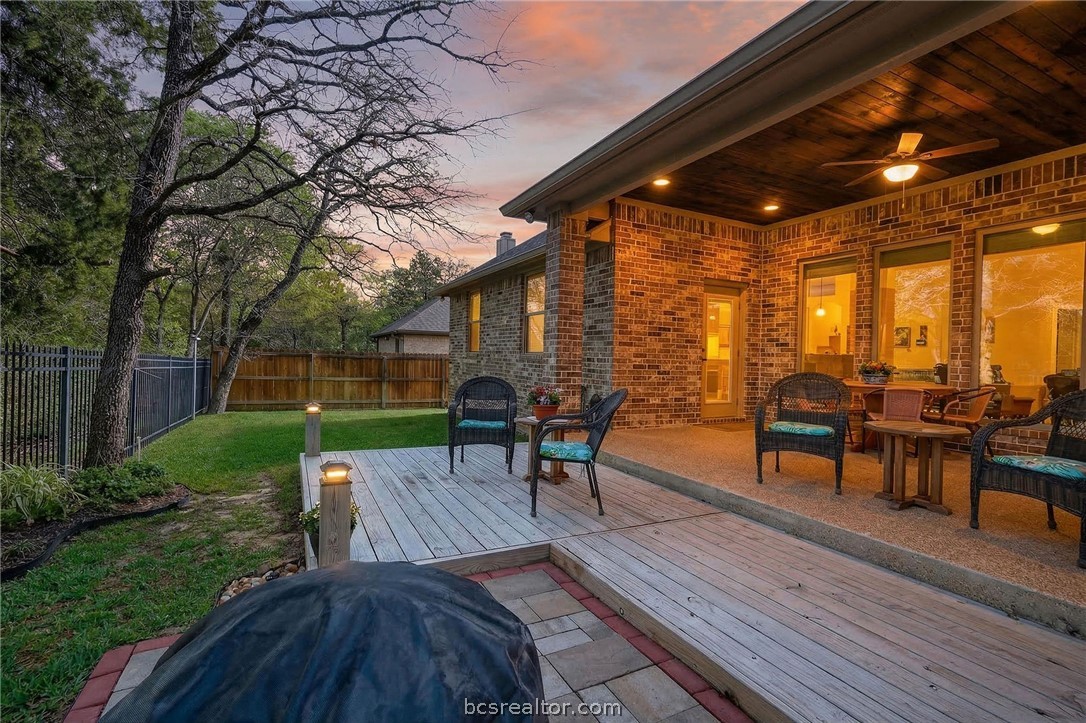 2004 Lexi Lane Bryan, TX 77807 - Photo 42 of 47 a view of a patio with table and chairs potted plants with wooden floor and fence