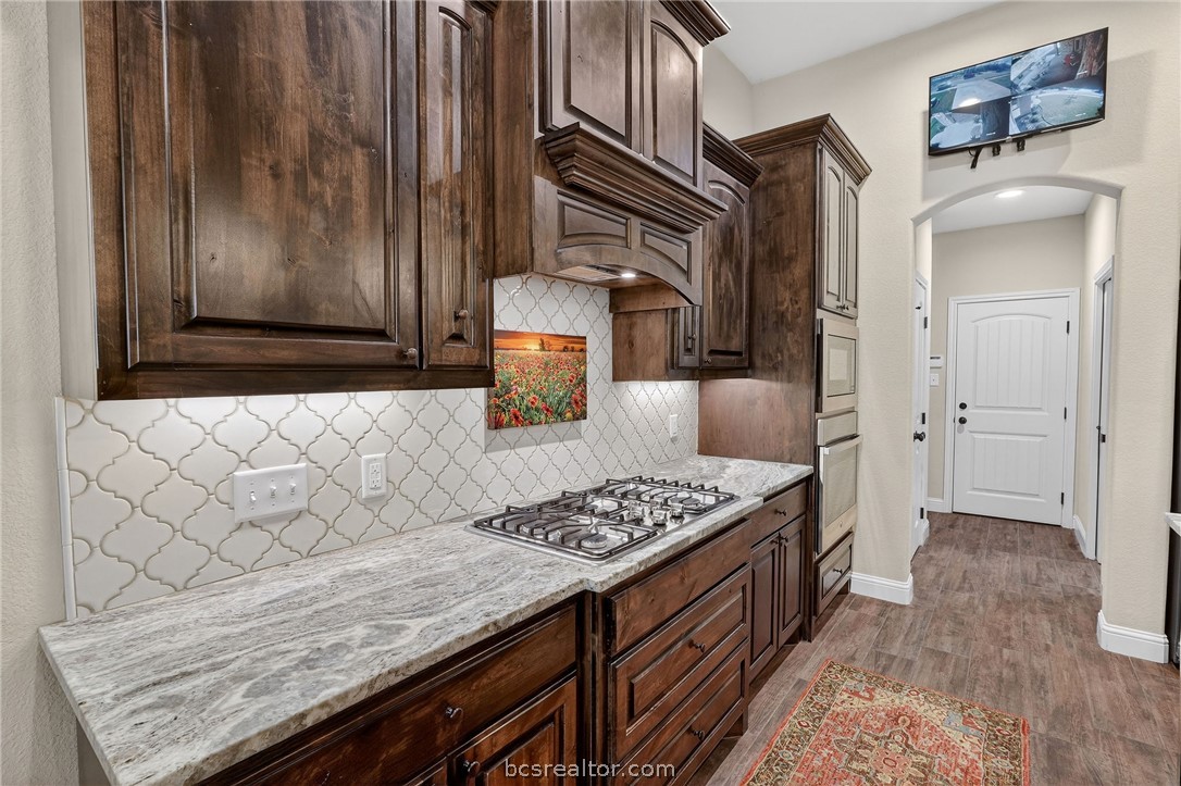 2004 Lexi Lane Bryan, TX 77807 - Photo 10 of 47 a kitchen with stainless steel appliances granite countertop a stove and a refrigerator