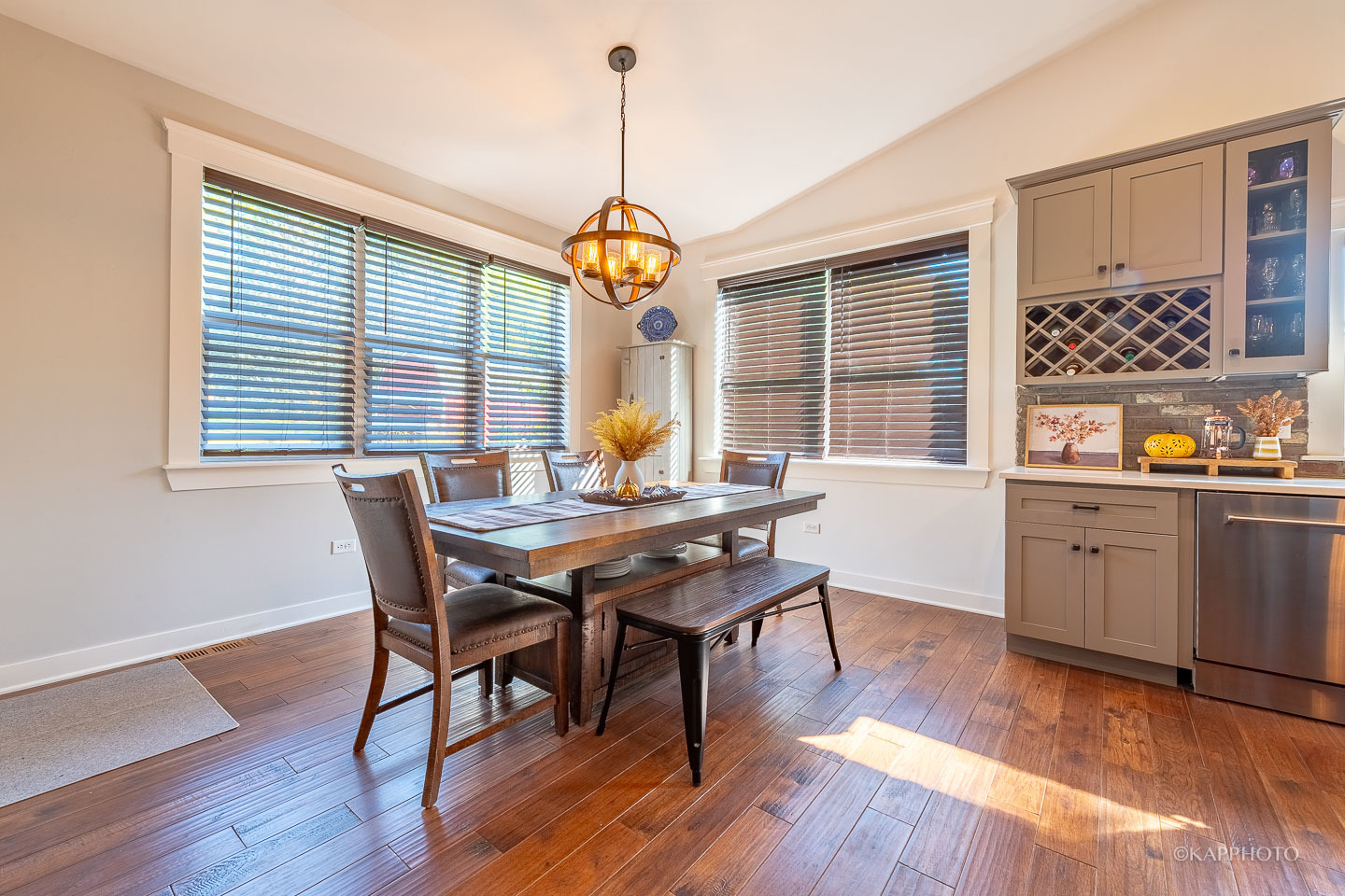 249 Easy Street Lake Holiday, IL 60552 - Photo 13 of 42 a dining room with wooden floor a chandelier a wooden table and chairs