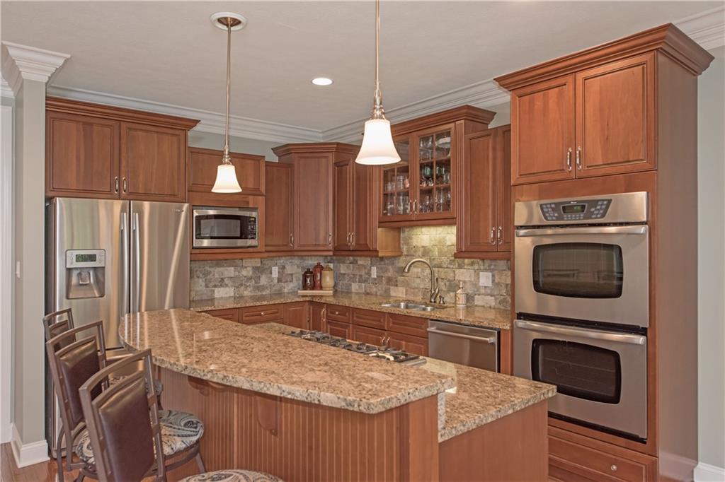 2019 Condor Lane Gibsonia, PA 15044 - Photo 12 of 39 a kitchen with kitchen island granite countertop a sink appliances and cabinets
