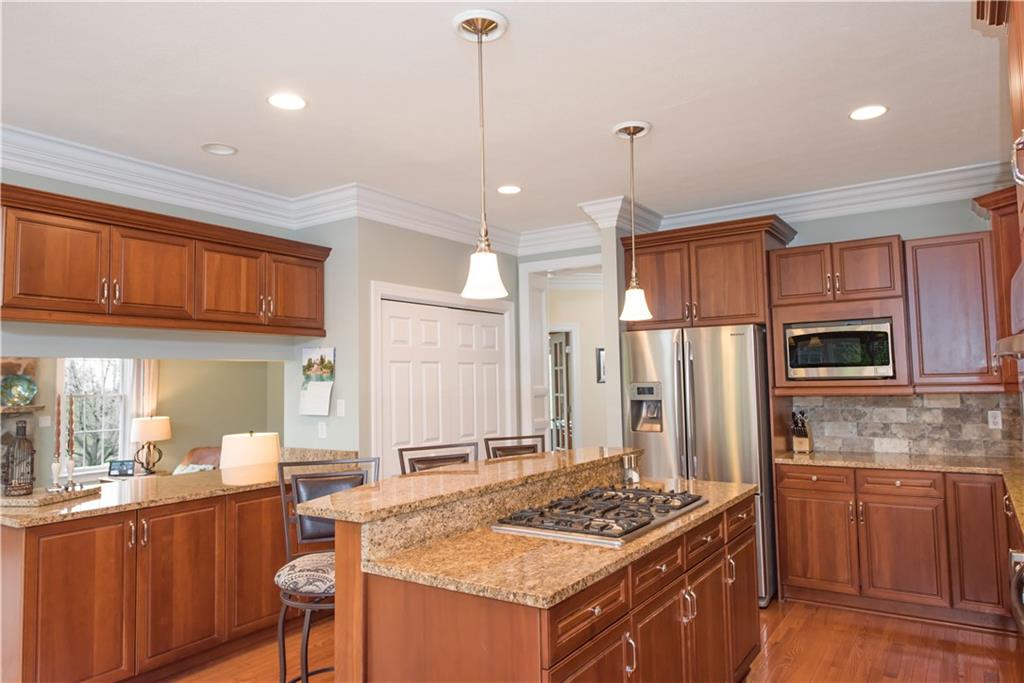 2019 Condor Lane Gibsonia, PA 15044 - Photo 13 of 39 a kitchen with stainless steel appliances granite countertop a stove a sink dishwasher and a refrigerator with wooden cabinets