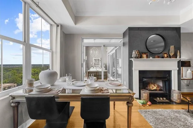 a view of a living room and kitchen floor to ceiling window and wooden floor