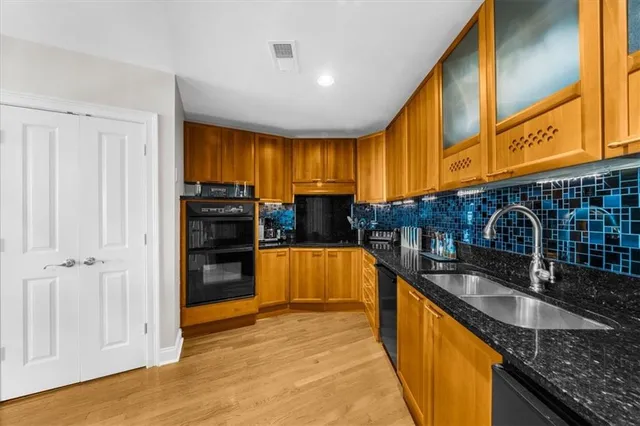 a view of kitchen with sink refrigerator and cabinets