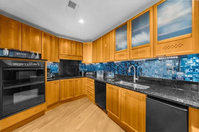 a living room with furniture a fireplace and a chandelier