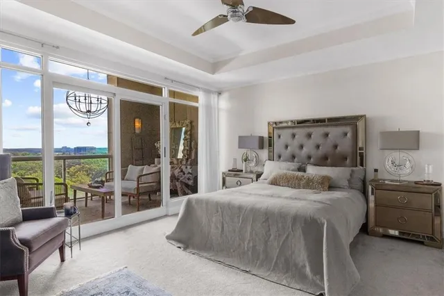 a bedroom with a bed and a large window