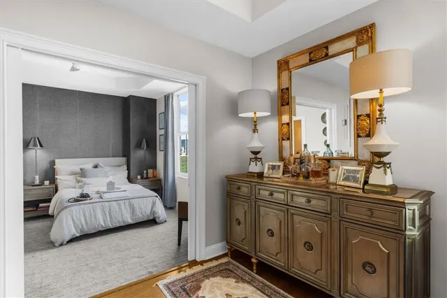 a bedroom with a bed a couch and a painting on the wall