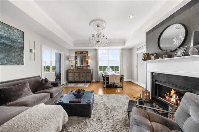 a living room with furniture and floor to ceiling windows